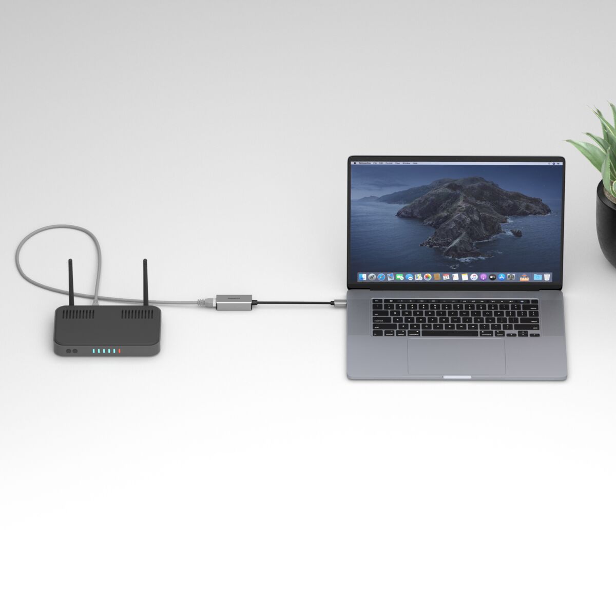USB-C to Ethernet adapter - Ambiance Image of a router connected to a laptop using an USB-C to Ethernet adapter | Marmitek